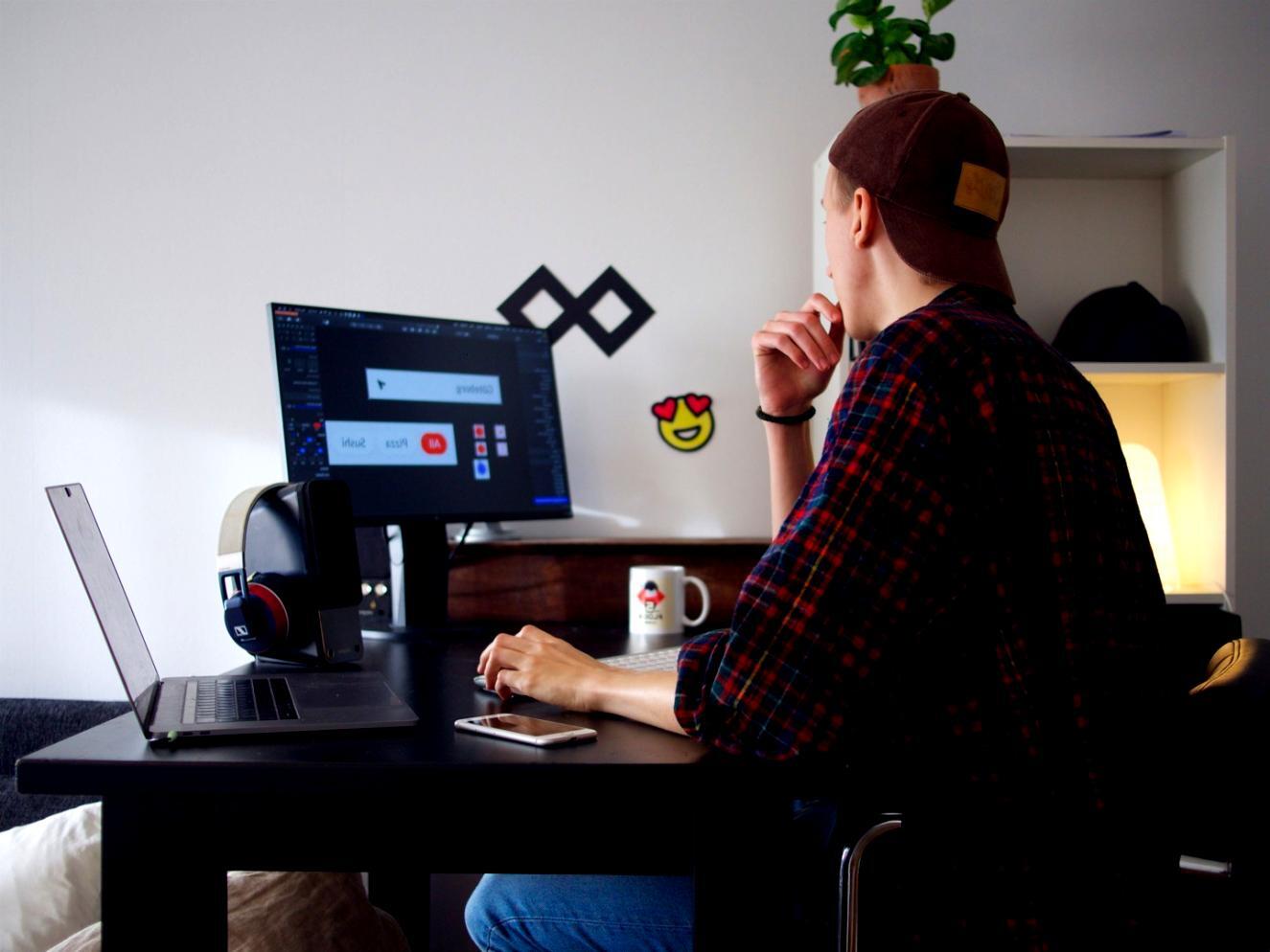 Team reviewing code analysis and debugging results on multiple monitors